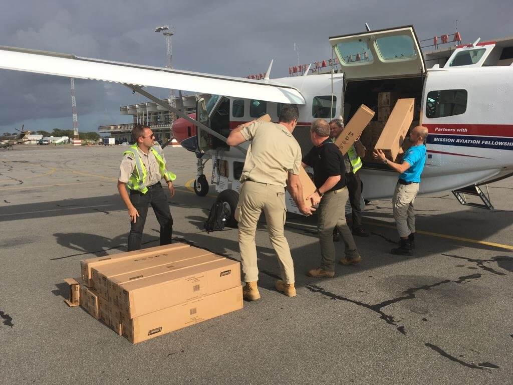 Mission Aviation Fellowship pilots and aid workers load the MAF Caravan aircraft with tents for temporary shelters after Cyclone Idai