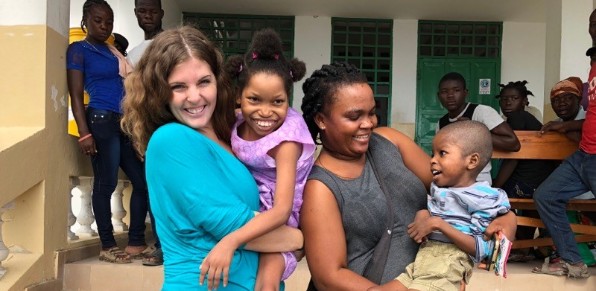 Two women holding orphaned children