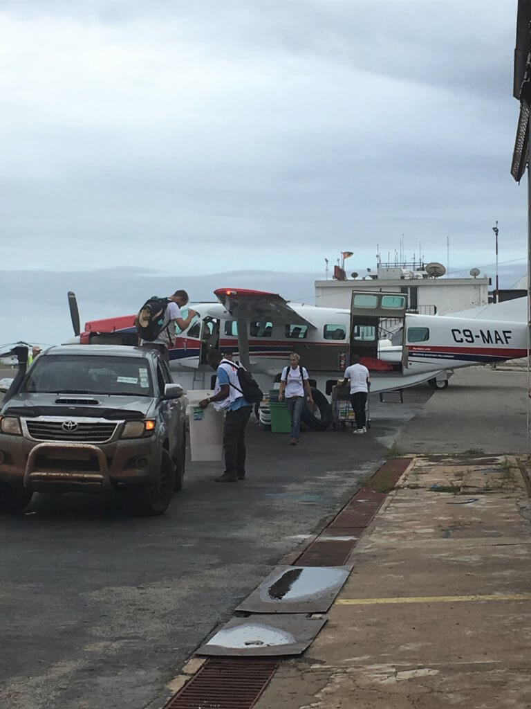 medical personnel load supplies onto Mission Aviation Fellowship charity airplane in Mozambique