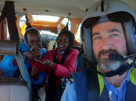 Neheng and Sebongile enjoying their M&Ms, and pilot Justin Honaker